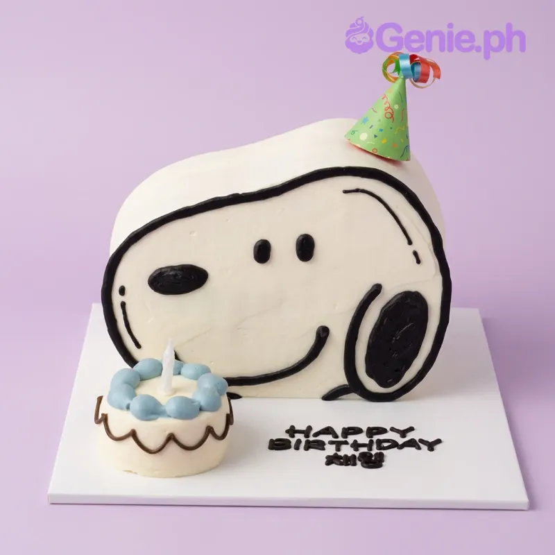 White 1 tier fondant cake with Snoopy face icing decorations, a party hat, a birthday candle, and a sky blue mini cake White 1 tier fondant cake with Snoopy face icing decorations, a party hat, a birthday candle, and a sky blue mini cake