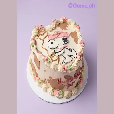 Snoopy Cowboy cake design — 1 layer soft icing cake in white — with Snoopy cowboy printout, pink piped roses, green piped leaves, brown cow print patches, and custom "Happy Birthday" message Snoopy Cowboy cake design — 1 layer soft icing cake in white — with Snoopy cowboy printout, pink piped roses, green piped leaves, brown cow print patches, and custom "Happy Birthday" message