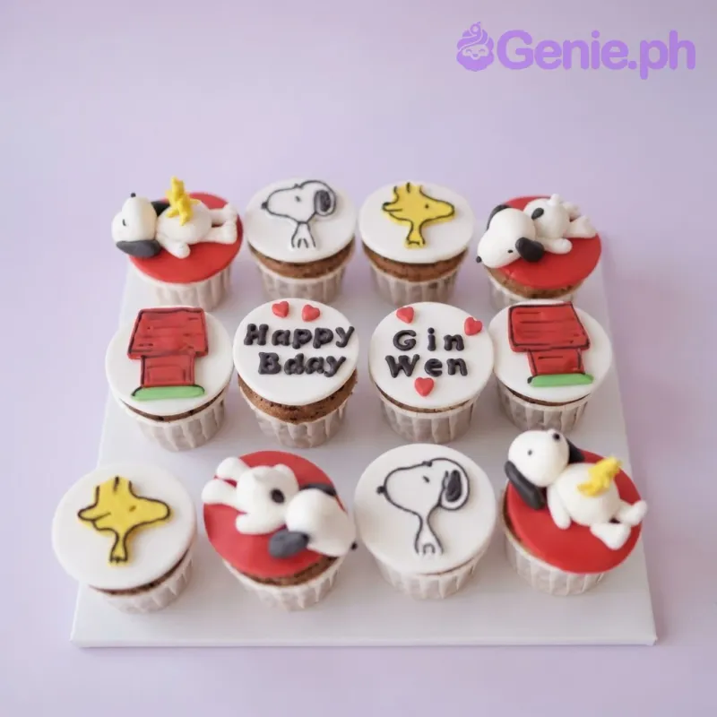 White and red Snoopy character cupcakes with sculpted fondant figures and themed edible art White and red Snoopy character cupcakes with sculpted fondant figures and themed edible art