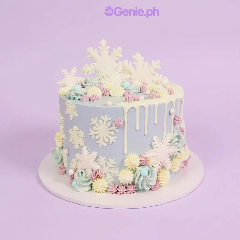 Light blue 1-tier cake with white fondant snowflake toppers and piped icing rosettes Light blue 1-tier cake with white fondant snowflake toppers and piped icing rosettes