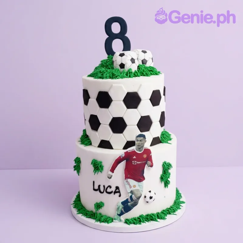 A white, green two-tier fondant Soccer Ronaldo cake with Ronaldo printout, number 8, and soccer pattern. A white, green two-tier fondant Soccer Ronaldo cake with Ronaldo printout, number 8, and soccer pattern.
