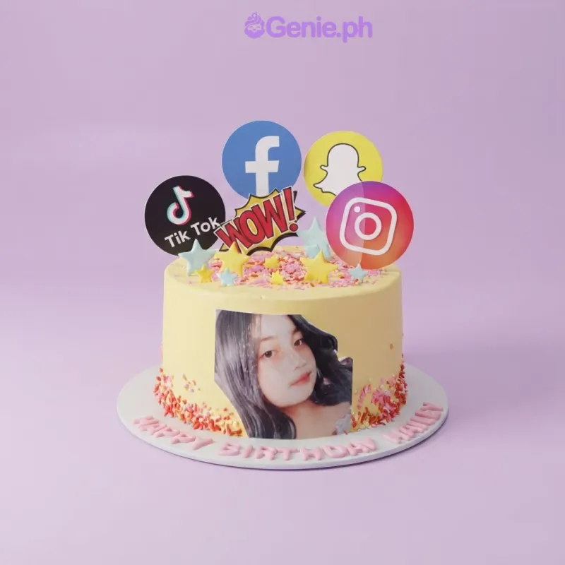 A yellow 1-tier cake themed around Social Media, featuring social media logos, a girl's photo, sprinkles, and stars. A yellow 1-tier cake themed around Social Media, featuring social media logos, a girl's photo, sprinkles, and stars.