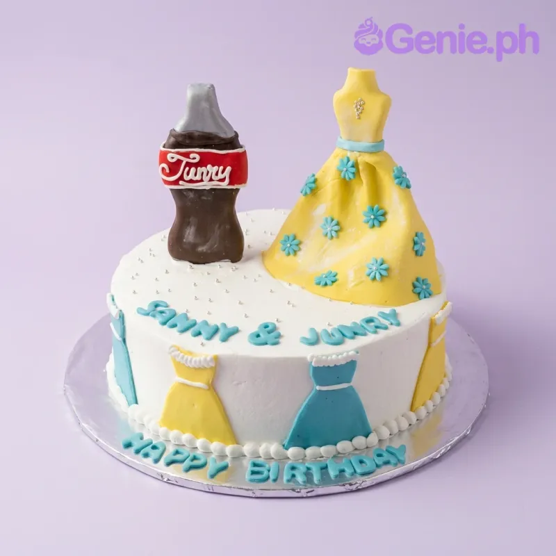 A white 1 Tier cake Soda And Dress, featuring a fondant soda bottle and yellow dress, with blue text and dress icing. A white 1 Tier cake Soda And Dress, featuring a fondant soda bottle and yellow dress, with blue text and dress icing.