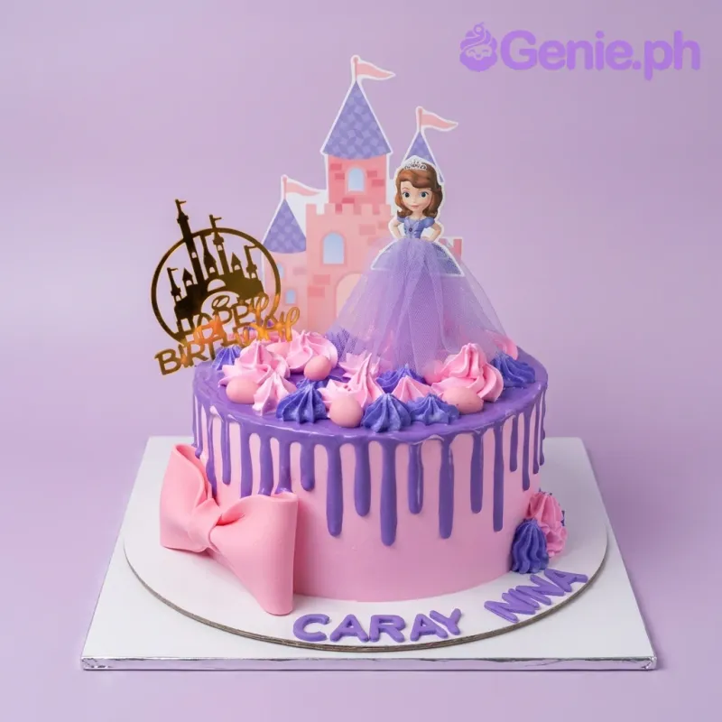 A pink and purple 1-tier Sofia The First cake, featuring Sofia, a castle, and 'Happy Birthday' topper, with a purple drip. A pink and purple 1-tier Sofia The First cake, featuring Sofia, a castle, and 'Happy Birthday' topper, with a purple drip.