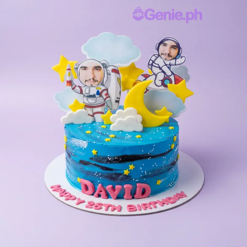 A blue 1-tier cake themed Space Astronaut, featuring astronaut printouts, a yellow moon, yellow stars, white clouds, and red gumpaste letters. A blue 1-tier cake themed Space Astronaut, featuring astronaut printouts, a yellow moon, yellow stars, white clouds, and red gumpaste letters.