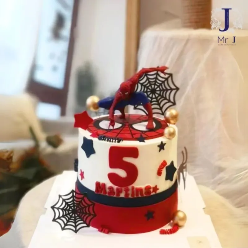 White and red 1-tier birthday cake with smooth soft icing, Spider-Man action figure, and web cutouts White and red 1-tier birthday cake with smooth soft icing, Spider-Man action figure, and web cutouts