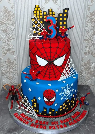 Red and blue 2-tier fondant Spiderman birthday cake with city skyline topper, action figures, and spider webs Red and blue 2-tier fondant Spiderman birthday cake with city skyline topper, action figures, and spider webs