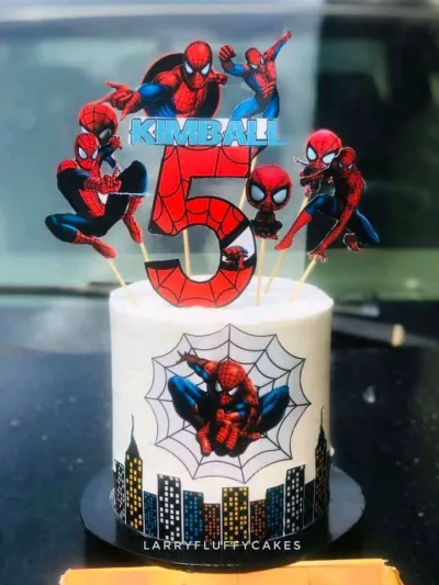 White 1-tier soft icing birthday cake with spiderman printouts, cityscape wrap, and a number 5 topper White 1-tier soft icing birthday cake with spiderman printouts, cityscape wrap, and a number 5 topper