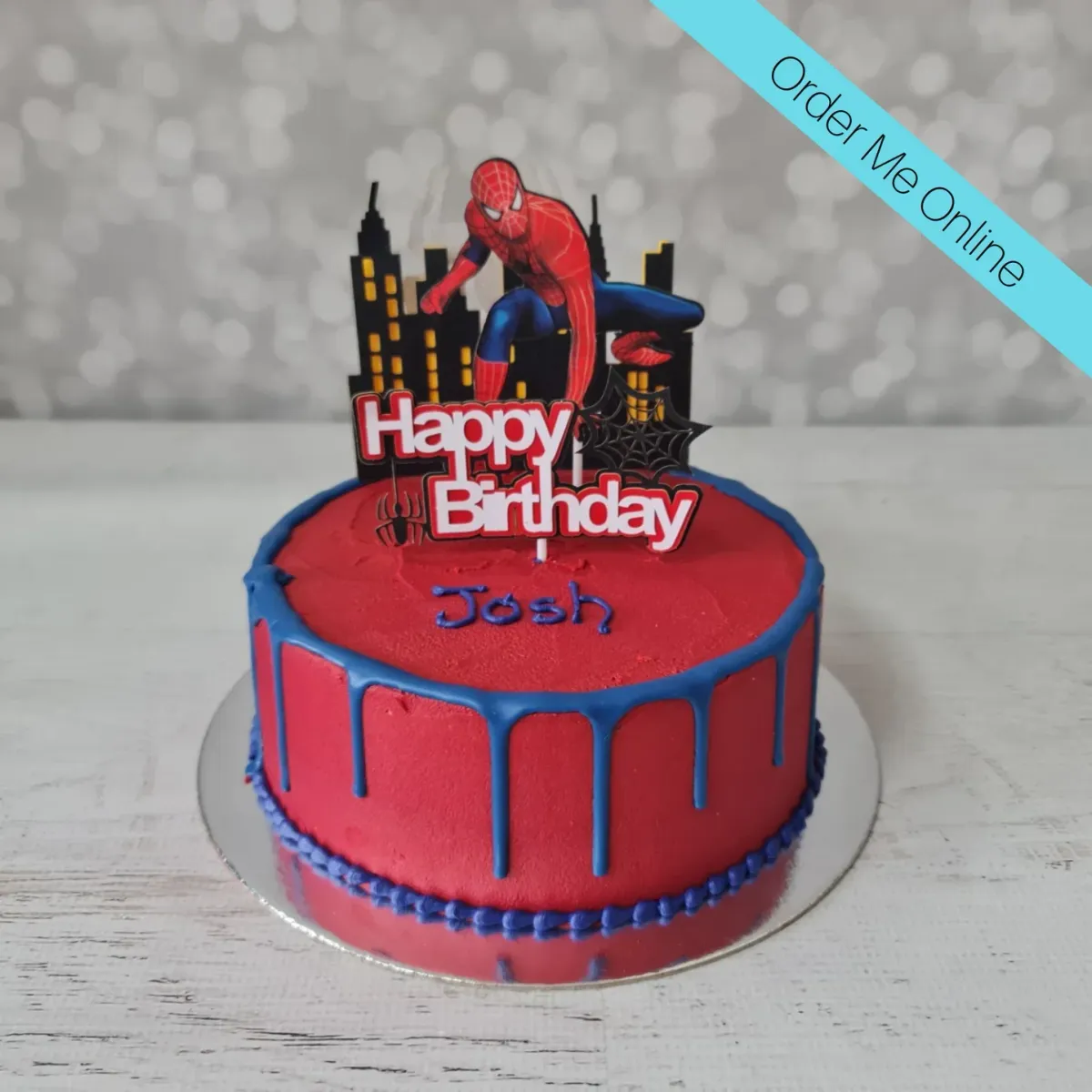Red 1-tier birthday cake with blue drip, Spiderman printout topper, and piped blue text Red 1-tier birthday cake with blue drip, Spiderman printout topper, and piped blue text