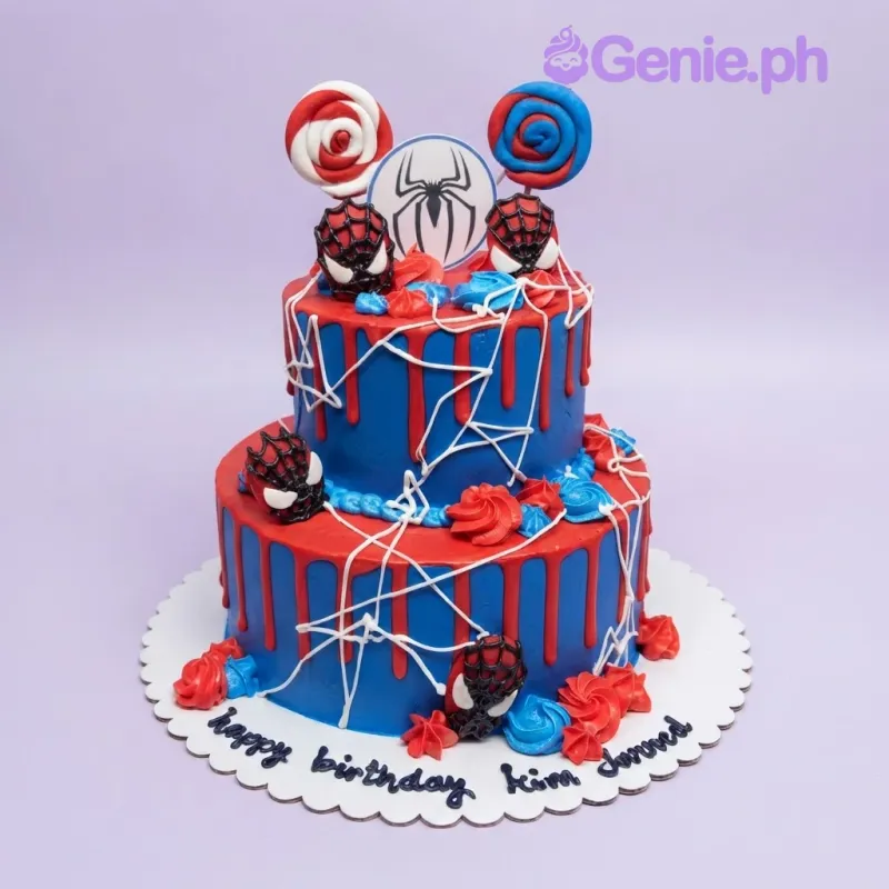 A blue, red, and white two-tier cake themed around Spiderman, featuring Spiderman mask and spider logo cutouts, red drips, and white webs. A blue, red, and white two-tier cake themed around Spiderman, featuring Spiderman mask and spider logo cutouts, red drips, and white webs.