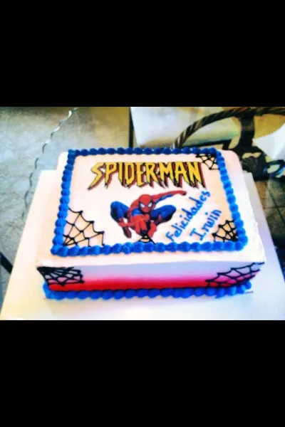White and red rectangular soft icing cake with a Spiderman edible photo top and blue piped borders White and red rectangular soft icing cake with a Spiderman edible photo top and blue piped borders