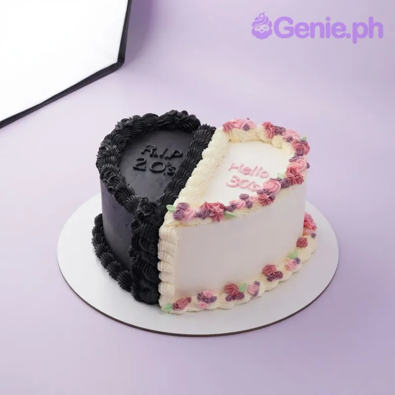 White 1-tier heart cake with soft icing, a black piped border on the left, and a pink piped flower garland on the right White 1-tier heart cake with soft icing, a black piped border on the left, and a pink piped flower garland on the right