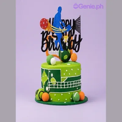 Green single tier sports themed cake with basketball player and soccer ball toppers Green single tier sports themed cake with basketball player and soccer ball toppers