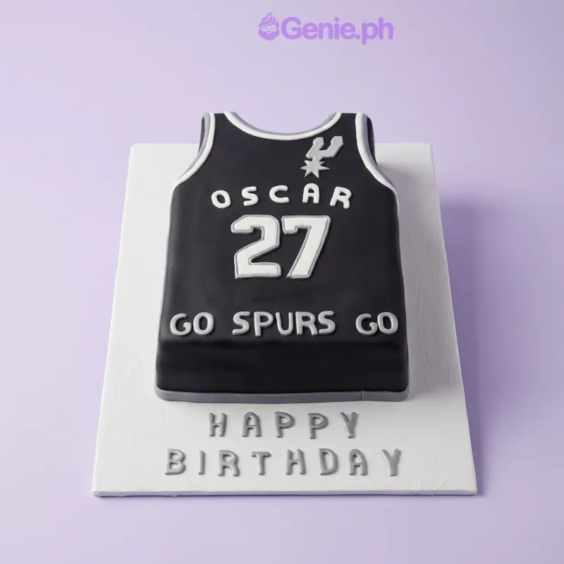 Black rectangular jersey-shaped cake with white text and Happy Birthday message on the board Black rectangular jersey-shaped cake with white text and Happy Birthday message on the board