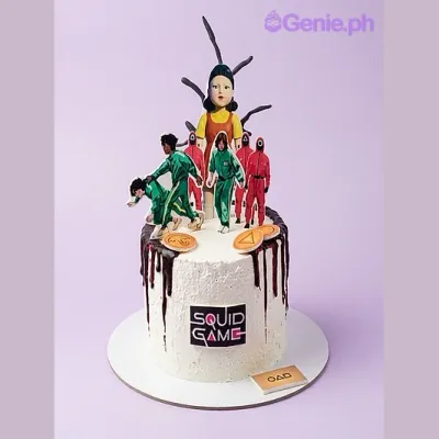 White 1-tier cake with Squid Game doll, characters, logo, and black chocolate drip White 1-tier cake with Squid Game doll, characters, logo, and black chocolate drip