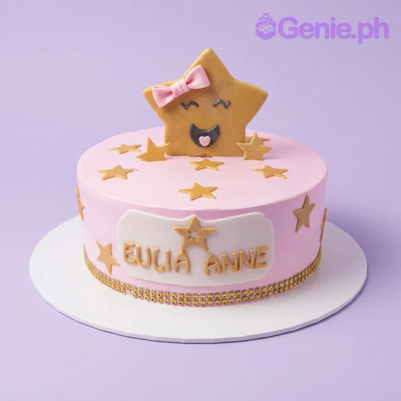 Pink round cake with a large smiling yellow star topper wearing a pink bow and smaller gold stars on the top and sides. Pink round cake with a large smiling yellow star topper wearing a pink bow and smaller gold stars on the top and sides.