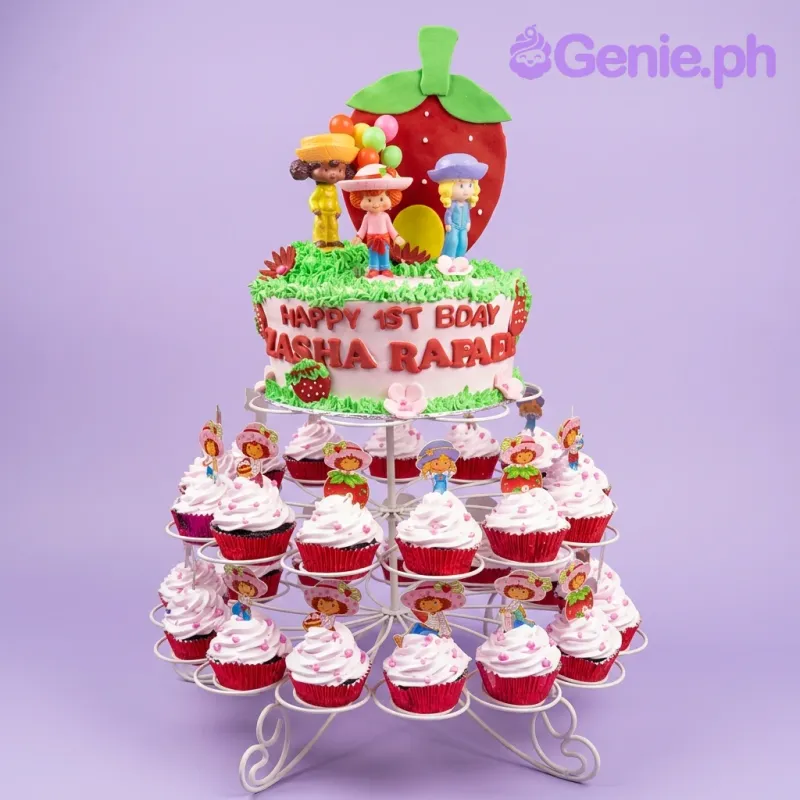 A white, red, and green 1-tier cake themed around Strawberry Shortcake, featuring character figures, a large strawberry, and piped grass. A white, red, and green 1-tier cake themed around Strawberry Shortcake, featuring character figures, a large strawberry, and piped grass.