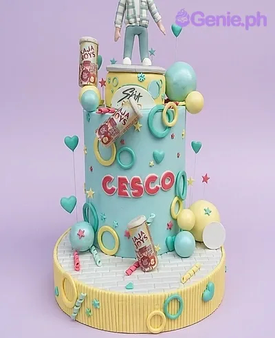 A light blue 1 Tier Fondant Stray Kids K-pop cake featuring a boy figure, soda cans, and colorful rings. A light blue 1 Tier Fondant Stray Kids K-pop cake featuring a boy figure, soda cans, and colorful rings.