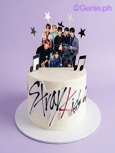 White single tier cake with a Stray Kids group photo, Stray Kids logo, glitter stars, and musical notes White single tier cake with a Stray Kids group photo, Stray Kids logo, glitter stars, and musical notes