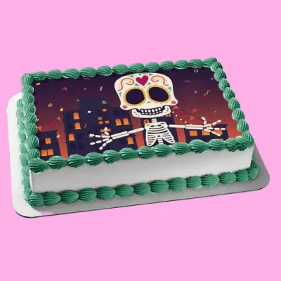 Rectangular white cake with green shell borders and a large edible photo print of a Day of the Dead sugar skull skeleton in a city. Rectangular white cake with green shell borders and a large edible photo print of a Day of the Dead sugar skull skeleton in a city.