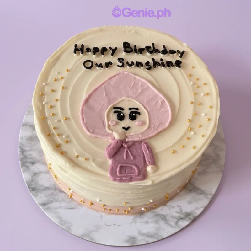 One tier ivory cake with a character in hoodie printout and gold and white sprinkles One tier ivory cake with a character in hoodie printout and gold and white sprinkles