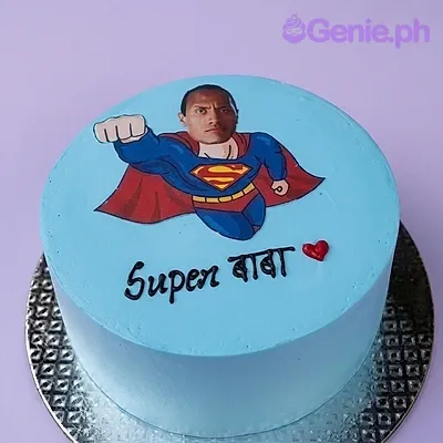 Light blue minimalist cake featuring a Superman body printout with a custom father's face and Super Baba message. Light blue minimalist cake featuring a Superman body printout with a custom father's face and Super Baba message.