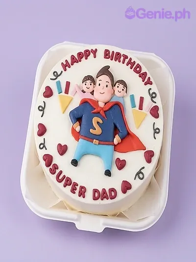 White single tier birthday cake with a 3D fondant superhero dad figure carrying two children and red heart icing decorations White single tier birthday cake with a 3D fondant superhero dad figure carrying two children and red heart icing decorations