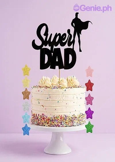 White single tier cake with rainbow sprinkles and a black Super Dad printout topper White single tier cake with rainbow sprinkles and a black Super Dad printout topper