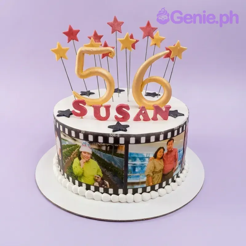 A white 1-tier birthday cake for Susan's 56th, with gold '56' toppers, film strip photos, and red and yellow stars. A white 1-tier birthday cake for Susan's 56th, with gold '56' toppers, film strip photos, and red and yellow stars.