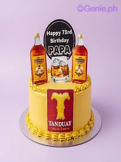 A yellow 1-tier cake themed around Tanduay Rum, featuring Tanduay Rum bottle and glass printouts with a birthday greeting. A yellow 1-tier cake themed around Tanduay Rum, featuring Tanduay Rum bottle and glass printouts with a birthday greeting.