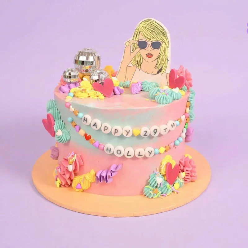 Pink and blue gradient birthday cake with Taylor Swift cutout and disco ball toppers Pink and blue gradient birthday cake with Taylor Swift cutout and disco ball toppers