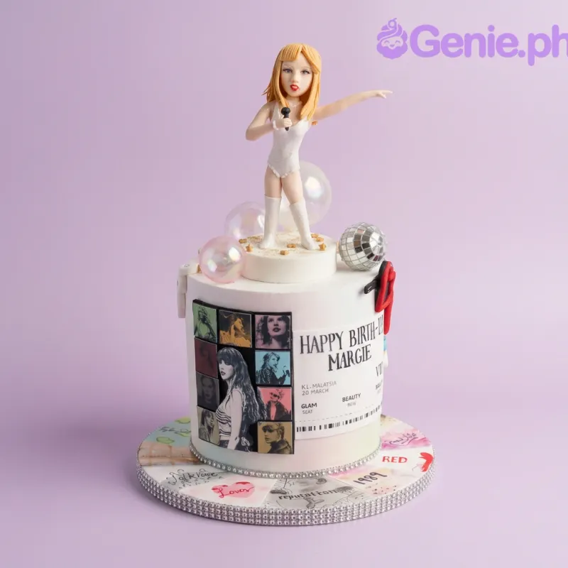White 1-tier fondant cake with a sculpted singer figurine, a disco ball, and a concert ticket printout on the side White 1-tier fondant cake with a sculpted singer figurine, a disco ball, and a concert ticket printout on the side