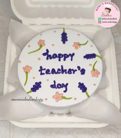 White bento cake with smooth soft icing, Teacher Day theme, four light pink flowers, and five purple sprigs White bento cake with smooth soft icing, Teacher Day theme, four light pink flowers, and five purple sprigs