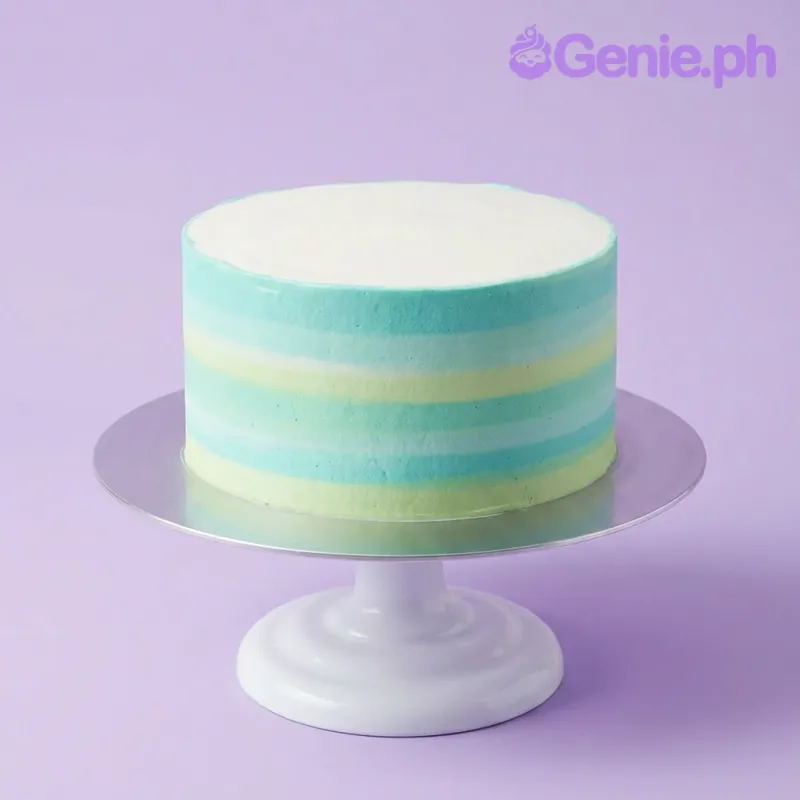 A white, teal, mint, and light green single tier round cake themed around Teal Gradient, featuring textured gradient icing with horizontal stripes. A white, teal, mint, and light green single tier round cake themed around Teal Gradient, featuring textured gradient icing with horizontal stripes.