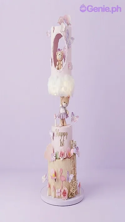 Pink 3-tier fondant cake with a teddy bear theme, featuring a hanging bear figurine, a cloud topper, and wood-textured bottom tier Pink 3-tier fondant cake with a teddy bear theme, featuring a hanging bear figurine, a cloud topper, and wood-textured bottom tier