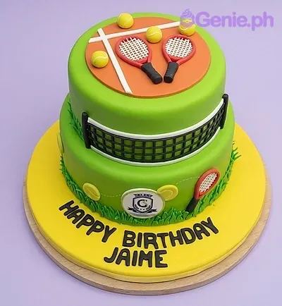 A green and yellow 2 Tier Fondant cake themed around Tennis, featuring red and black rackets, a black and white net, and yellow tennis balls. A green and yellow 2 Tier Fondant cake themed around Tennis, featuring red and black rackets, a black and white net, and yellow tennis balls.
