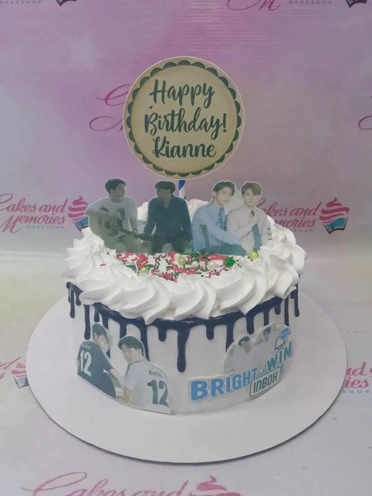White 1-tier birthday cake with blue chocolate drip, white icing swirls, and Thai actor printout toppers for Kianne. White 1-tier birthday cake with blue chocolate drip, white icing swirls, and Thai actor printout toppers for Kianne.