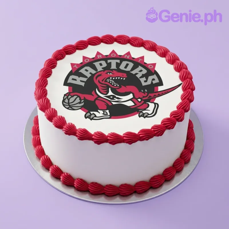 A white and red round 1-tier cake themed Toronto Raptors, featuring a large logo printout and red shell borders. A white and red round 1-tier cake themed Toronto Raptors, featuring a large logo printout and red shell borders.