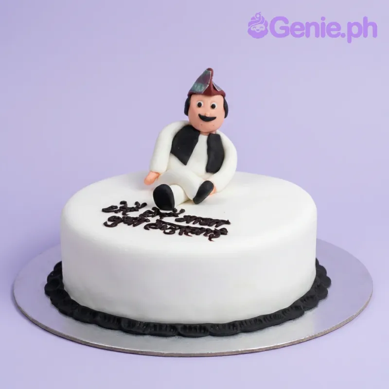 White fondant cake with a 3D edible figure of a man in traditional attire and black piped message. White fondant cake with a 3D edible figure of a man in traditional attire and black piped message.