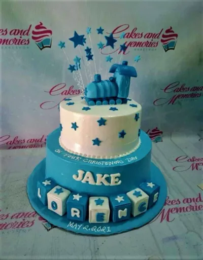 Blue and white 2-tier train themed christening cake with fondant stars and name blocks. Blue and white 2-tier train themed christening cake with fondant stars and name blocks.