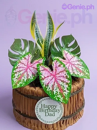 A brown and black 1-tier barrel cake themed Tropical Dad, with green and pink tropical leaves and 'Happy Birthday Dad' message. A brown and black 1-tier barrel cake themed Tropical Dad, with green and pink tropical leaves and 'Happy Birthday Dad' message.