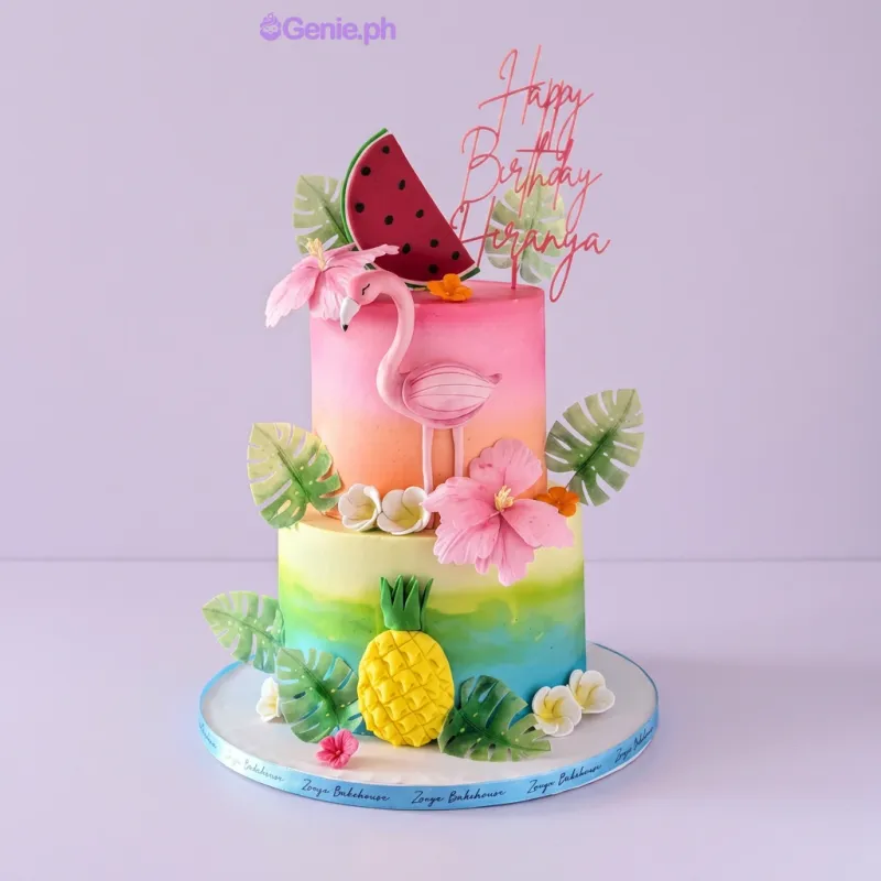Pink and orange gradient 2-tier cake with a flamingo topper, watermelon slice, pineapple, and tropical hibiscus flowers Pink and orange gradient 2-tier cake with a flamingo topper, watermelon slice, pineapple, and tropical hibiscus flowers