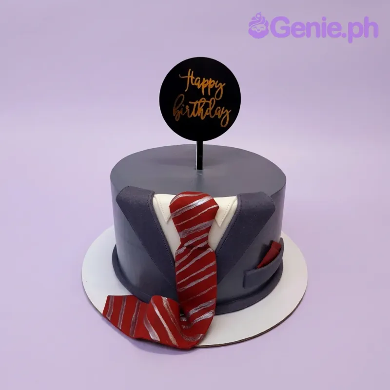 A gray 1 Tier Fondant cake themed around a Tuxedo, featuring a black 'Happy Birthday' topper, red and silver striped tie, and white collar. A gray 1 Tier Fondant cake themed around a Tuxedo, featuring a black 'Happy Birthday' topper, red and silver striped tie, and white collar.