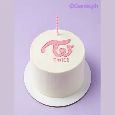 White round cake with pink piped Twice logo and text and a pink spiral candle on top White round cake with pink piped Twice logo and text and a pink spiral candle on top