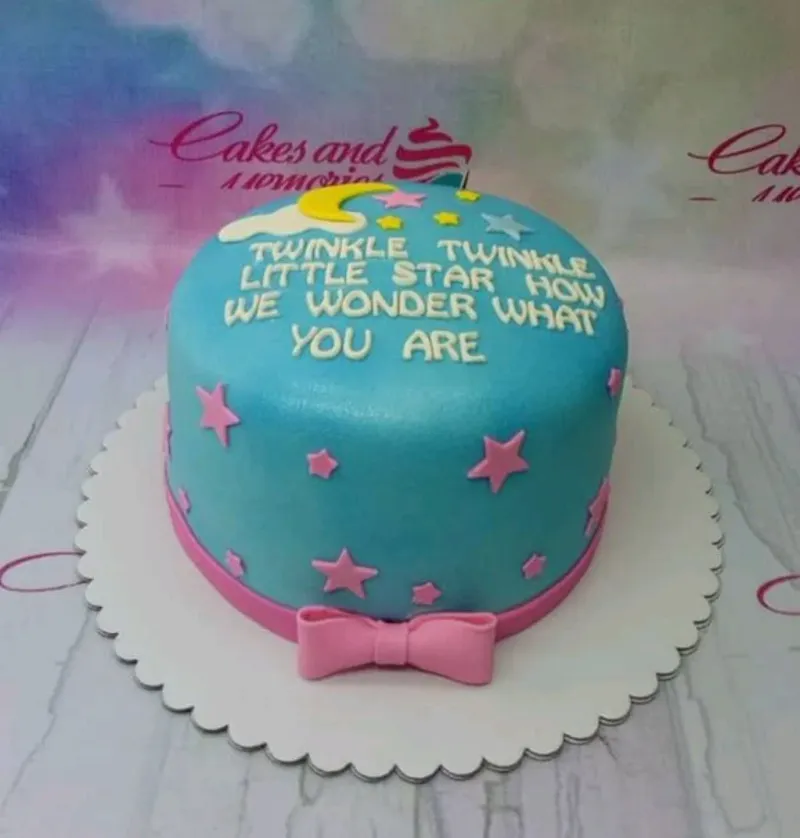 Light blue fondant cake with pink stars, a yellow moon, and white clouds featuring a Twinkle Twinkle Little Star message. Light blue fondant cake with pink stars, a yellow moon, and white clouds featuring a Twinkle Twinkle Little Star message.