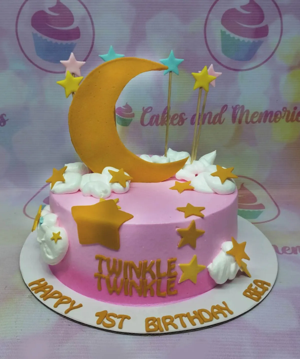 Pink gradient birthday cake with a large yellow crescent moon, stars, and white icing clouds. Pink gradient birthday cake with a large yellow crescent moon, stars, and white icing clouds.