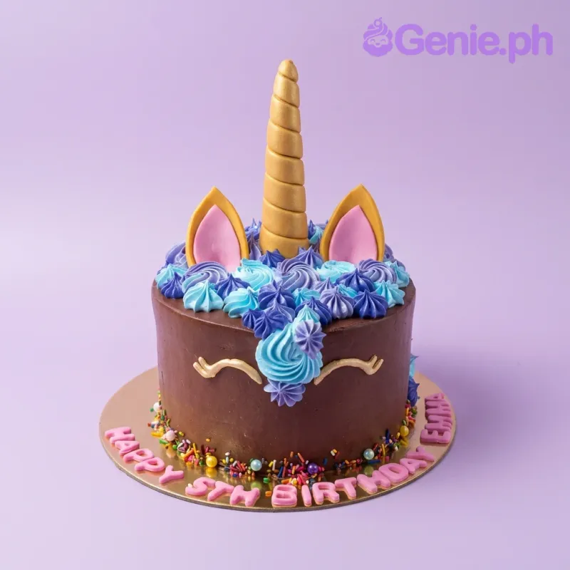 A chocolate 1-tier cake themed around Unicorn, featuring a gold horn, pink ears, blue and purple rosettes, and a pink message on a gold board. A chocolate 1-tier cake themed around Unicorn, featuring a gold horn, pink ears, blue and purple rosettes, and a pink message on a gold board.