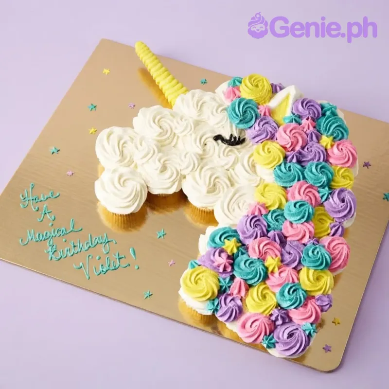 Unicorn pull-apart cupcake with white, pink, teal, and purple icing rosettes, a yellow fondant horn, and piped eye Unicorn pull-apart cupcake with white, pink, teal, and purple icing rosettes, a yellow fondant horn, and piped eye