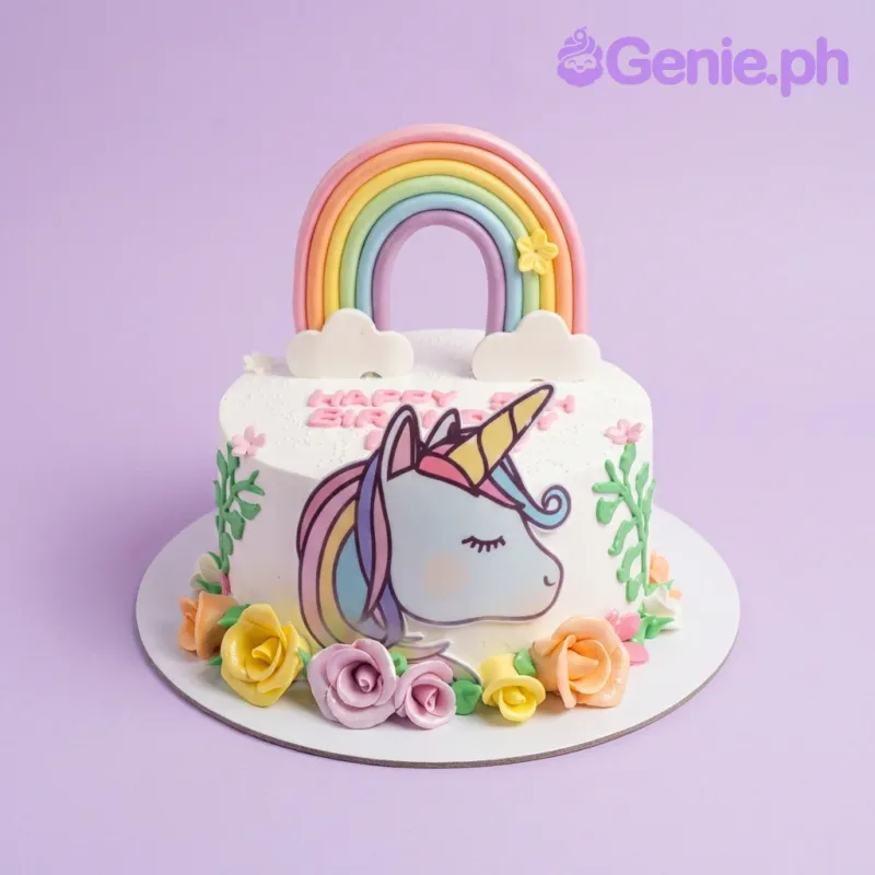 A white 1 Tier cake themed around Unicorn, featuring a large rainbow topper, a unicorn face, a pink icing message, and colorful fondant roses. A white 1 Tier cake themed around Unicorn, featuring a large rainbow topper, a unicorn face, a pink icing message, and colorful fondant roses.