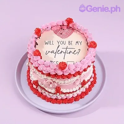 A pink and red 1-Tier Valentine Vintage cake, featuring a 'Will you be my Valentine' printout, ruffles, and rosettes. A pink and red 1-Tier Valentine Vintage cake, featuring a 'Will you be my Valentine' printout, ruffles, and rosettes.